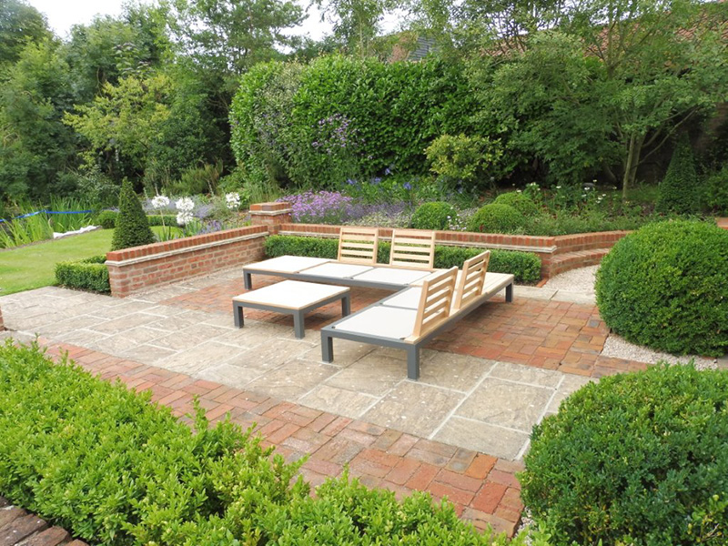 Brick and stone terrace, walling and planting Private garden
