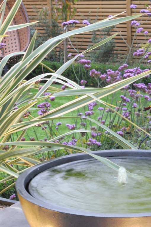 Private garden , Faux lead bowl water feature & verbena